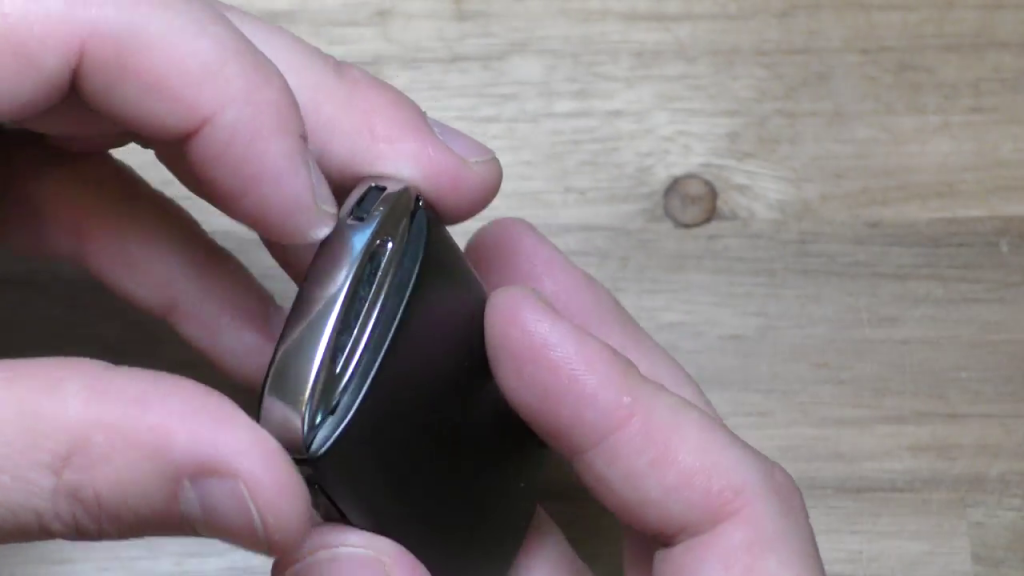 Moving tab on end of Mazda 2019 Key Fob to release panel