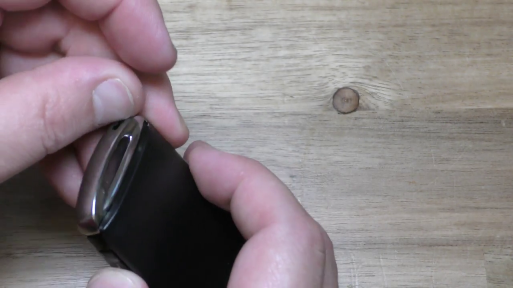 Moving tab on end of Mazda 2019 Key Fob to release panel